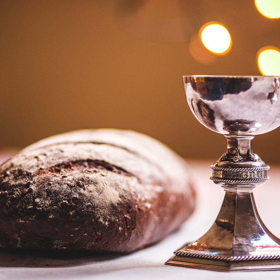 gray footed cup beside baguette bread