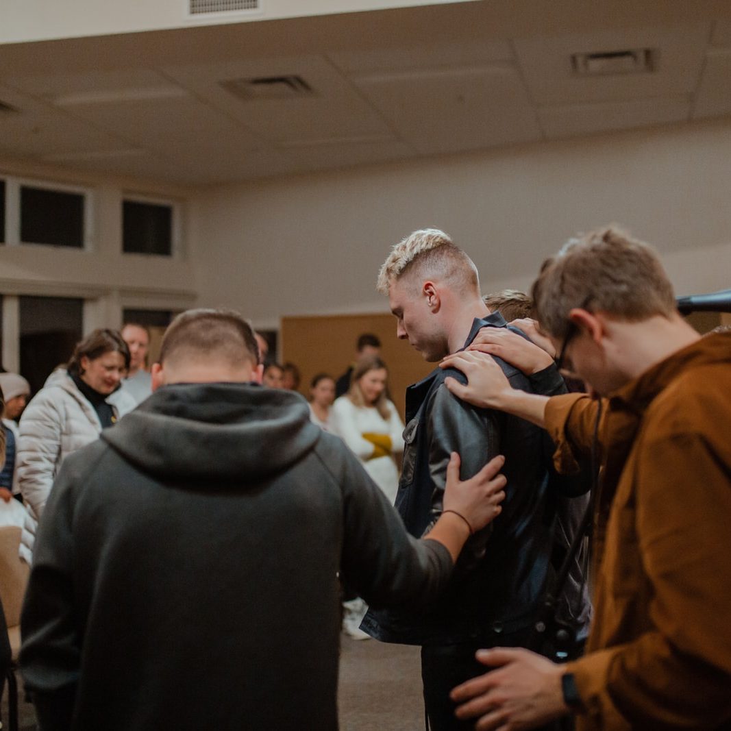 people in black and brown jackets standing in front of people